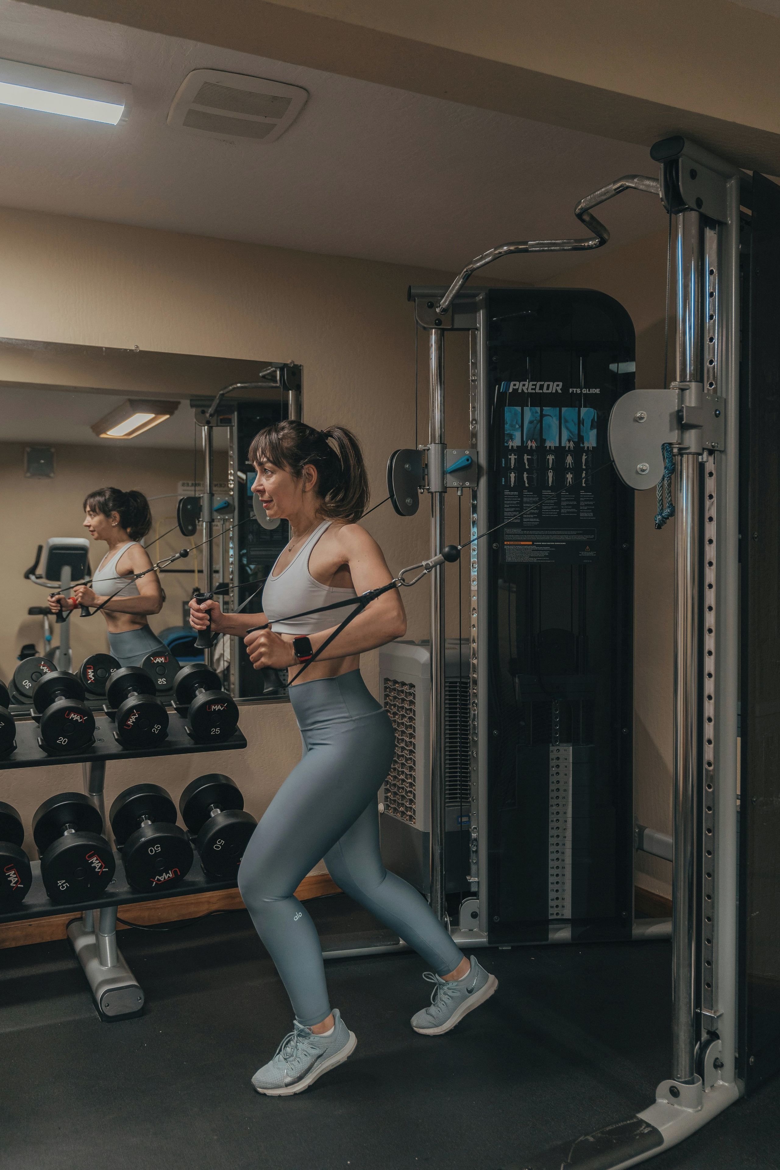 A gym with exercise equipment and dumbbells.
