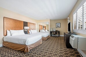 A hotel room with two beds, a desk, a television, and a window with blinds. - Marin Suites Hotel (Corte Madera)