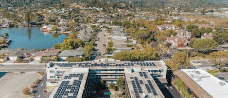 A building with a rooftop parking area and a swimming pool.