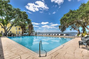 Relax by the serene pool surrounded by lounge chairs and scenic views.