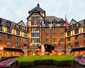 Experience the grandeur of this historic hotel, featuring a central tower and beautifully maintained gardens.