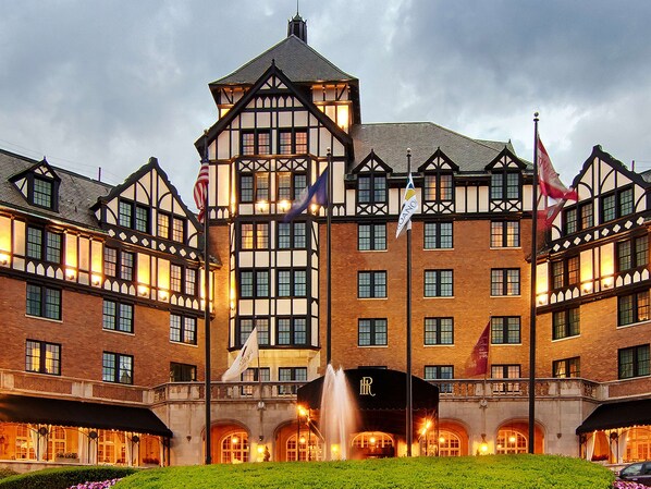 Stately historic building with a prominent entrance, brick and timber framing, and a central tower.
