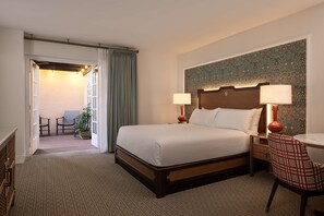 Relax in comfort with a large bed, bedside tables, and a desk, plus a balcony with a view.