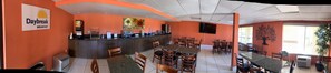 Enjoy a meal at Daybreak Breakfast, where a central counter offers a variety of food and beverage options, and multiple tables provide seating for all.