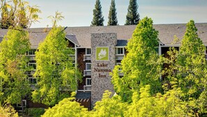 A multi-story building with a stone facade and a sign reading "Lake Natoma Inn."