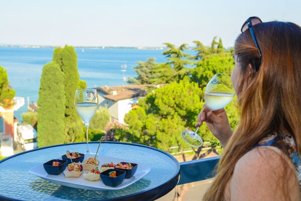 A person enjoying a meal with a view of the sea.