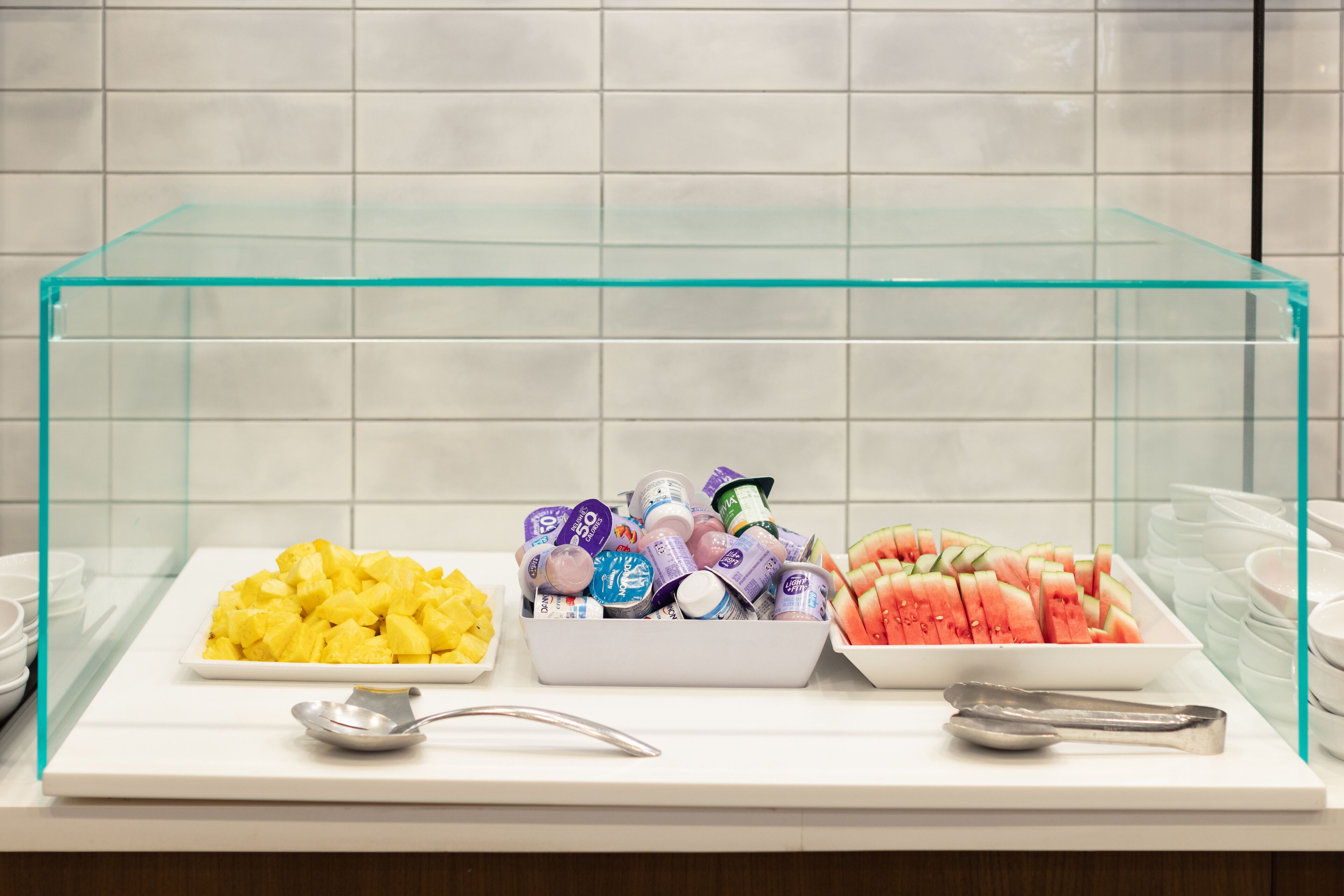 A buffet with various food items and condiments.