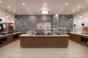 A modern kitchen area with a central island, equipped with various appliances and a beverage dispenser. - Embassy Suites by Hilton Tucson East (Tucson)