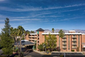 A hotel with multiple floors, a parking lot, and a mountainous backdrop. - Embassy Suites by Hilton Tucson East (Tucson)