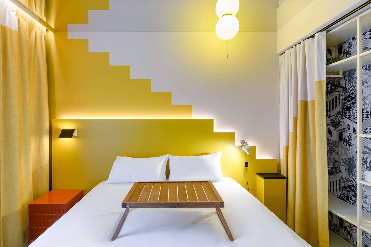 Premium bedding, desk, laptop workspace, blackout drapes
