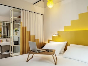Premium bedding, desk, laptop workspace, blackout drapes