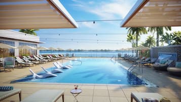 Una piscina al aire libre, camas de piscina con cargo, sombrillas