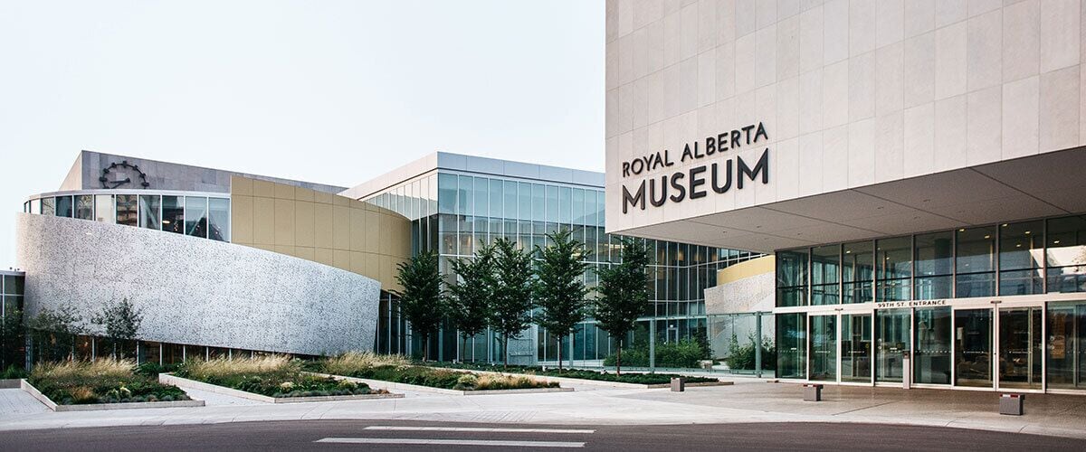 The exterior of the Royal Alberta Museum with a modern architectural design, featuring large glass windows and a prominent entrance.