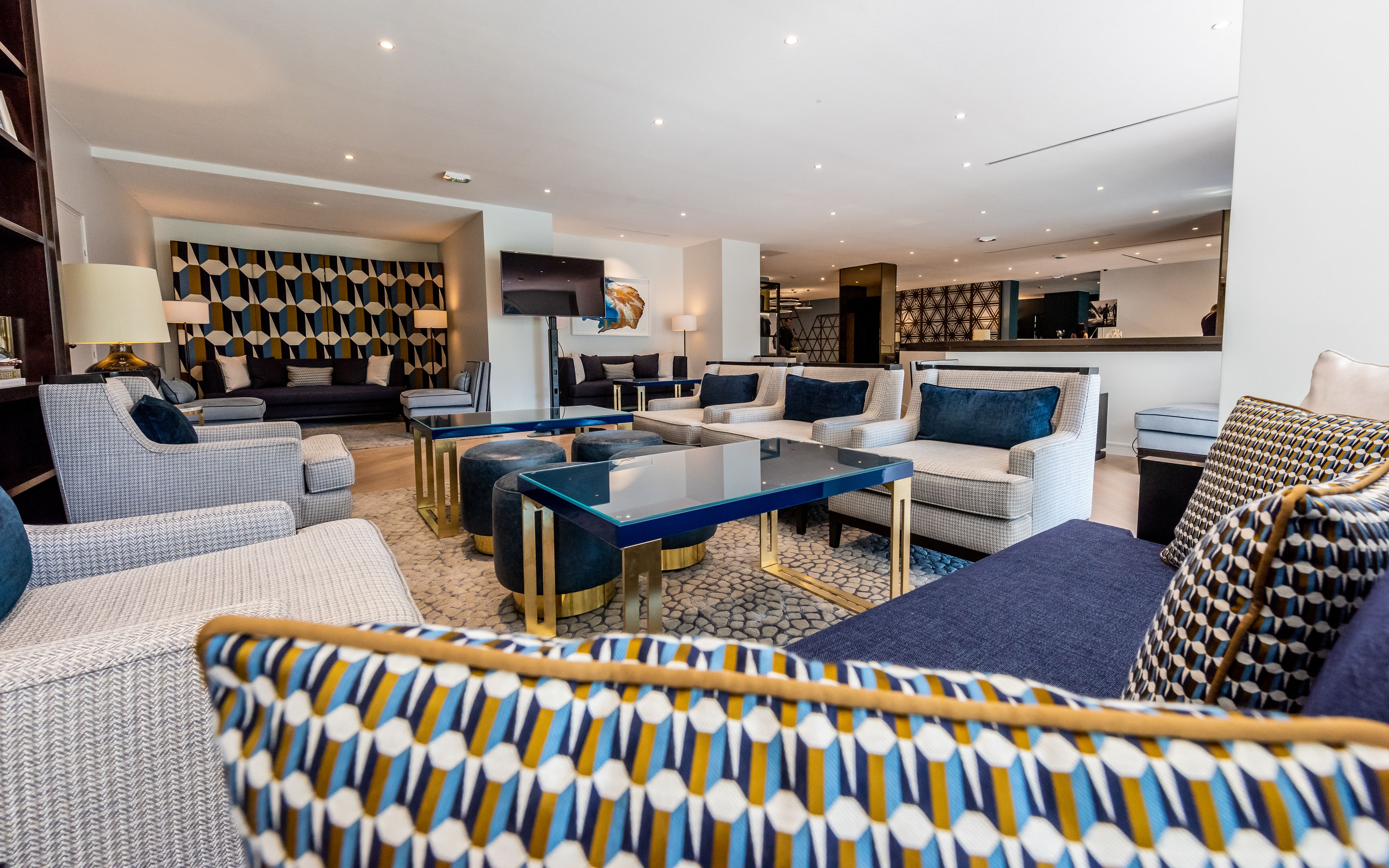 A modern living room with a sofa set, a coffee table, and a TV.