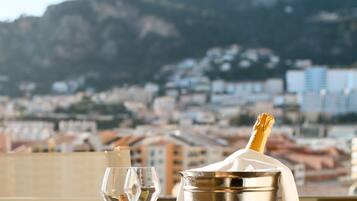 A table with a champagne bucket, two glasses, and macarons.