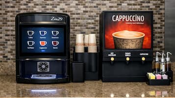 A coffee machine with a digital display, a cappuccino dispenser, and a stack of disposable cups.