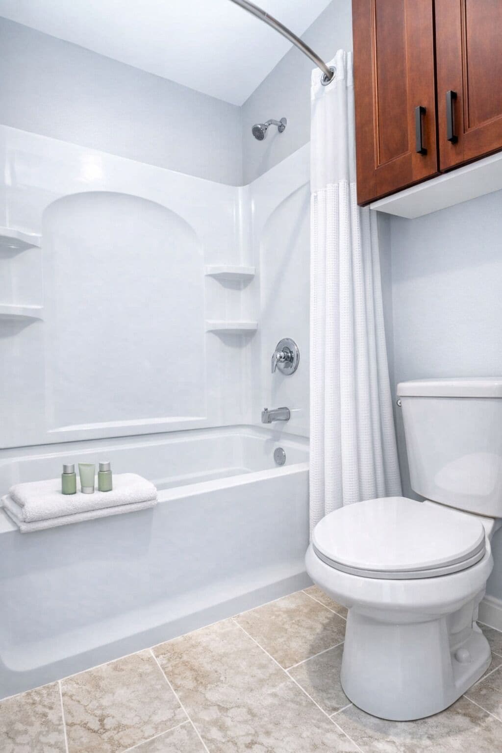 A bathroom with a bathtub, toilet, and a shower curtain.