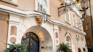 A hotel with a prominent entrance, a sign reading "HOTEL ALTA", and a traditional European architectural style. - Radisson Blu Hotel Altstadt (Salzburg)