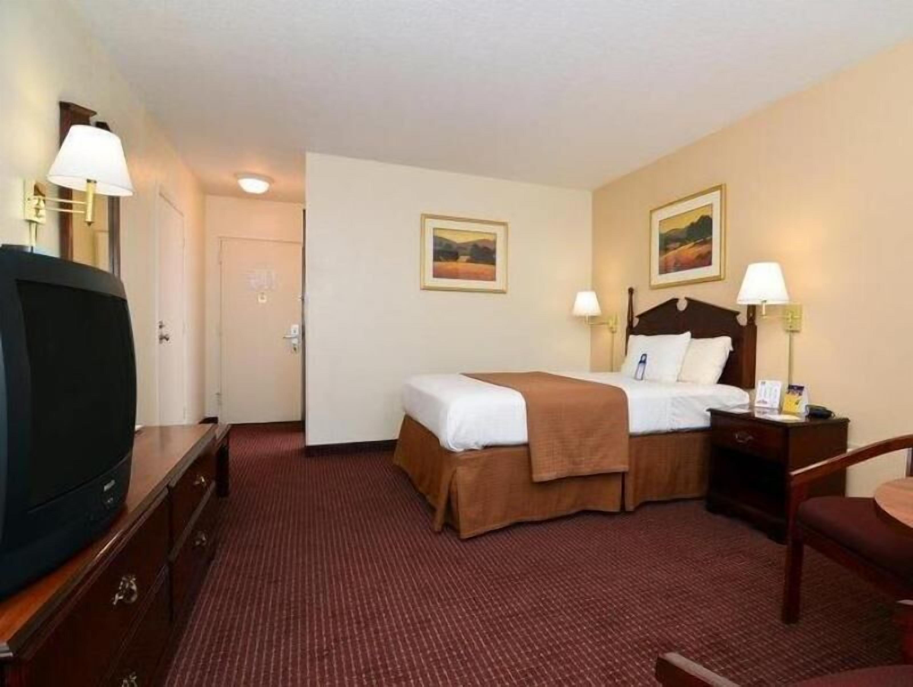 Desk, laptop workspace, blackout drapes, iron/ironing board