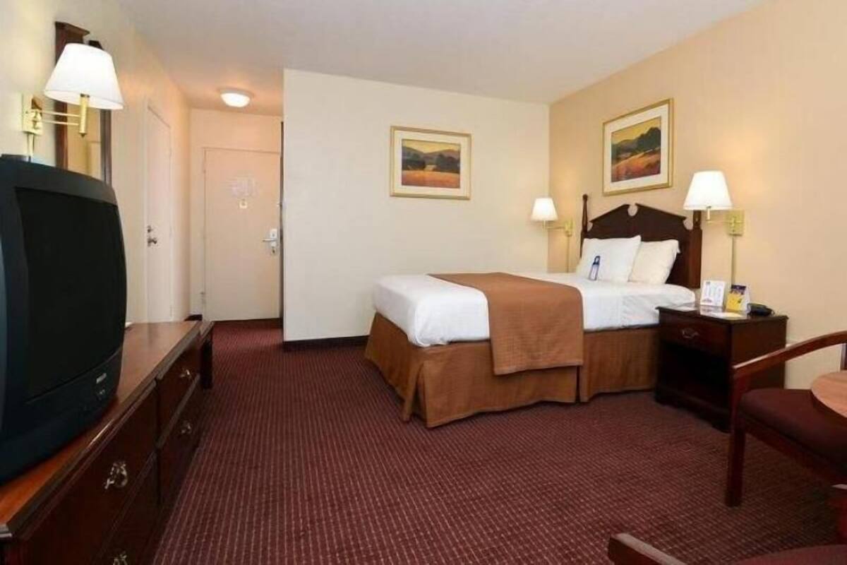 Desk, laptop workspace, blackout drapes, iron/ironing board