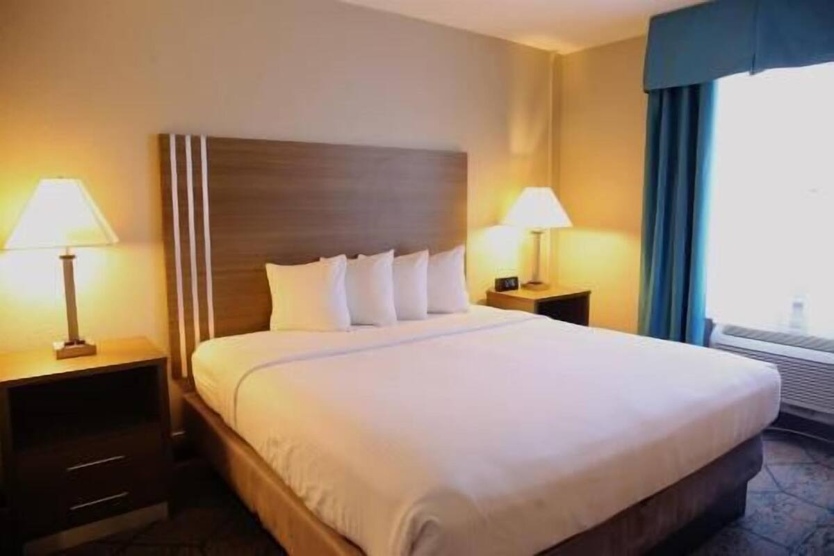 Desk, laptop workspace, blackout drapes, iron/ironing board