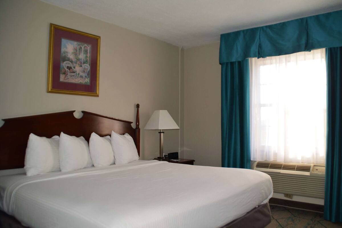 Desk, laptop workspace, blackout drapes, iron/ironing board