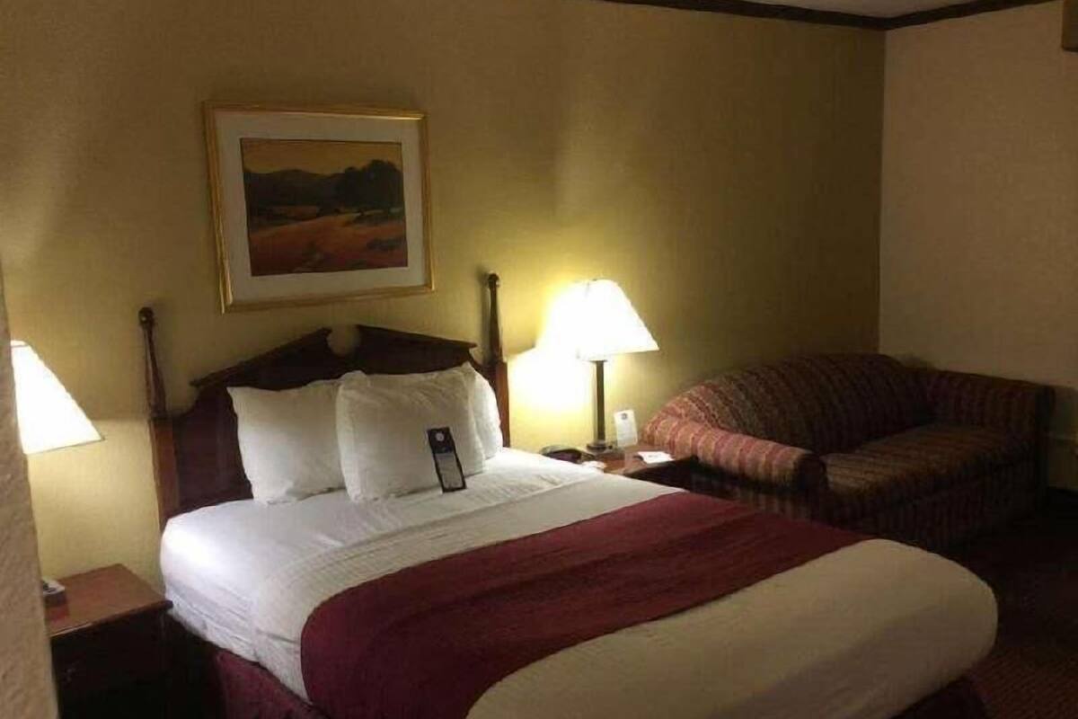 Desk, laptop workspace, blackout drapes, iron/ironing board