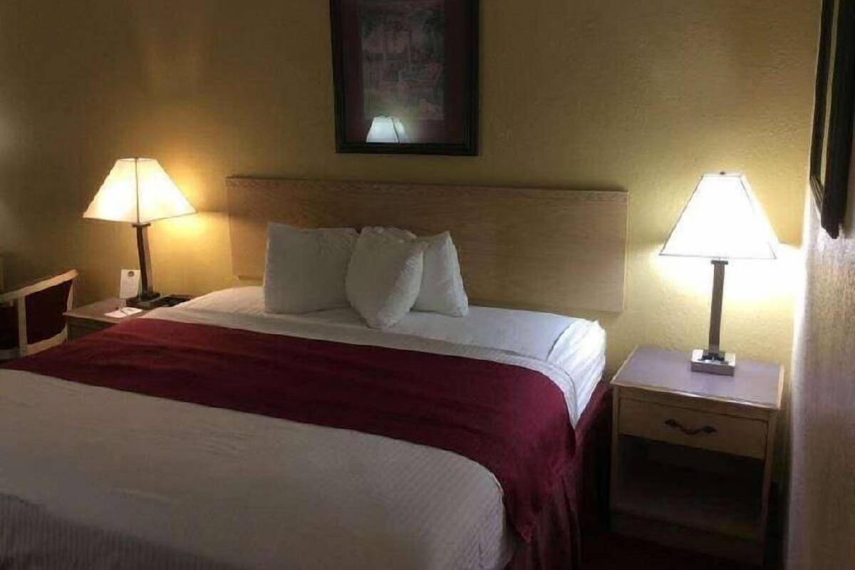 Desk, laptop workspace, blackout drapes, iron/ironing board