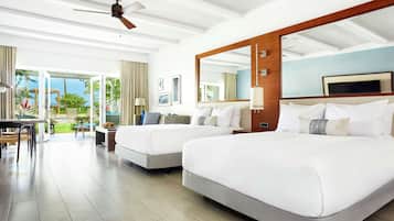 A hotel room with two beds, a large window, and a ceiling fan.