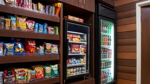 A snack vending machine stocked with chips, cookies, and beverages. - Fairfield Inn & Suites Cheyenne (Cheyenne)