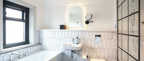 A modern bathroom with a freestanding bathtub, a toilet, and a sink.