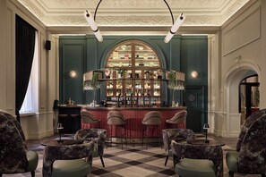 A bar area with a checkered floor, bar stools, and a bar counter with shelves of bottles. - The Met Hotel Leeds - Newly Refurbished (Leeds)