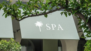 A spa with a modern architectural design, featuring a prominent 'SPA' sign and a seating area with a chair. - Palm Mountain Resort and Spa (Palm Springs)