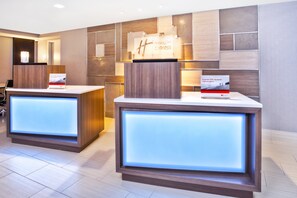 A reception area with two reception desks, each with a sign for Holiday Inn Express. - Holiday Inn Express Boston - Waltham by IHG (Waltham)