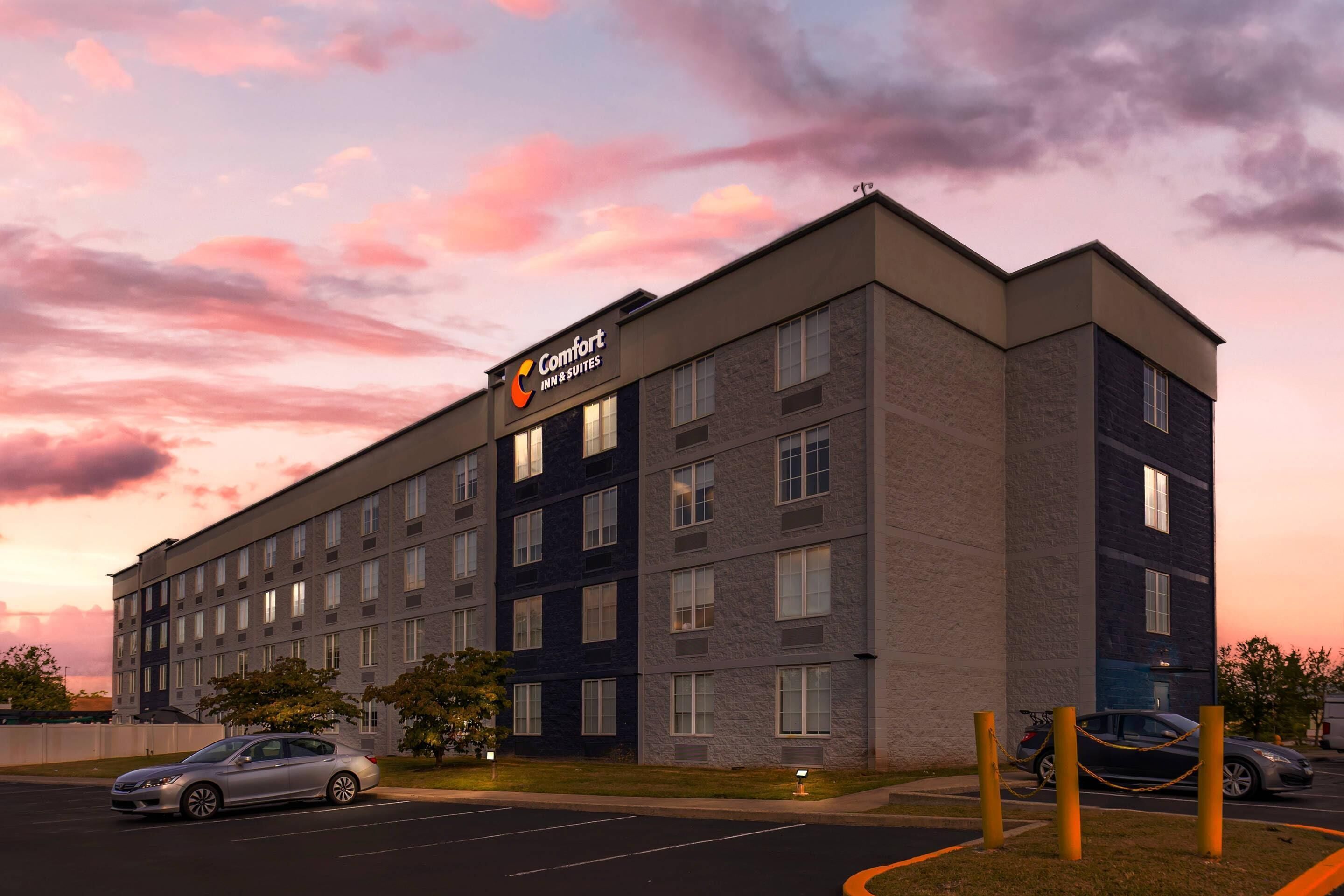 A multi-story hotel building with a prominent Comfort Inn & Suites sign.