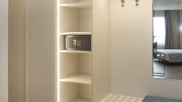 A modern closet with built-in shelves and a bench, a control panel, and a mirror.