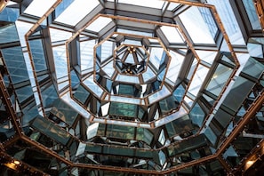 A geometric glass ceiling structure with a central hexagonal pattern.