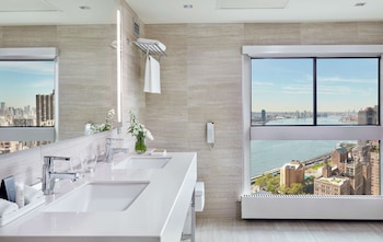 Eco-friendly toiletries, hair dryer, towels, soap at Millennium Hilton New York One UN Plaza