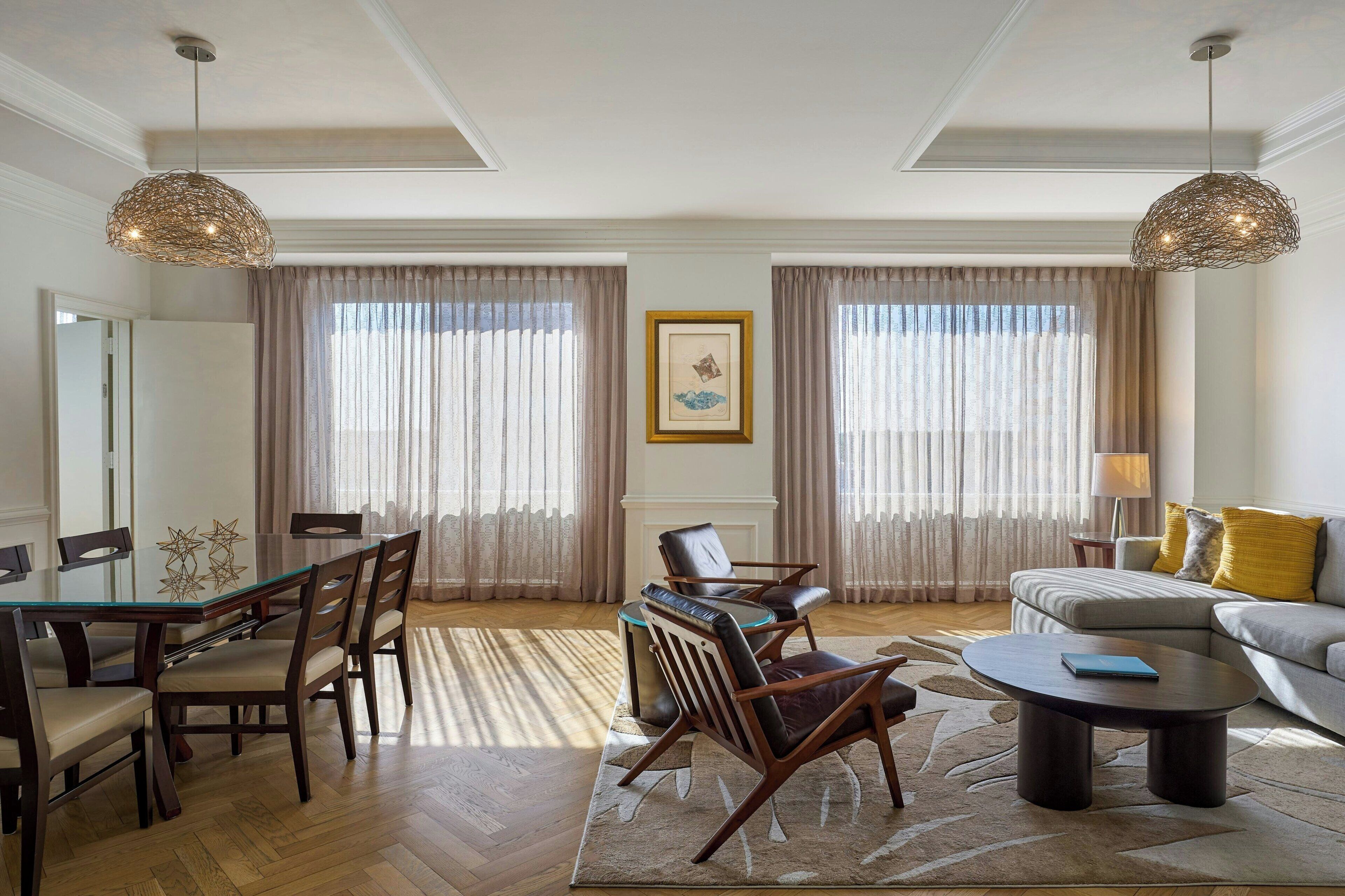 A spacious living room with a dining area, a sofa, and a coffee table.