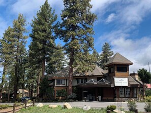A two-story building with a prominent 'HiMark Hotel' sign, large windows, and a stone facade. - HiMark (South Lake Tahoe)
