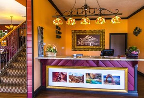 Welcome to Mountain View Lodge, where a warm and inviting atmosphere awaits. Enjoy stunning views and a cozy reception area with a fireplace, comfortable seating, and beautiful artwork.
