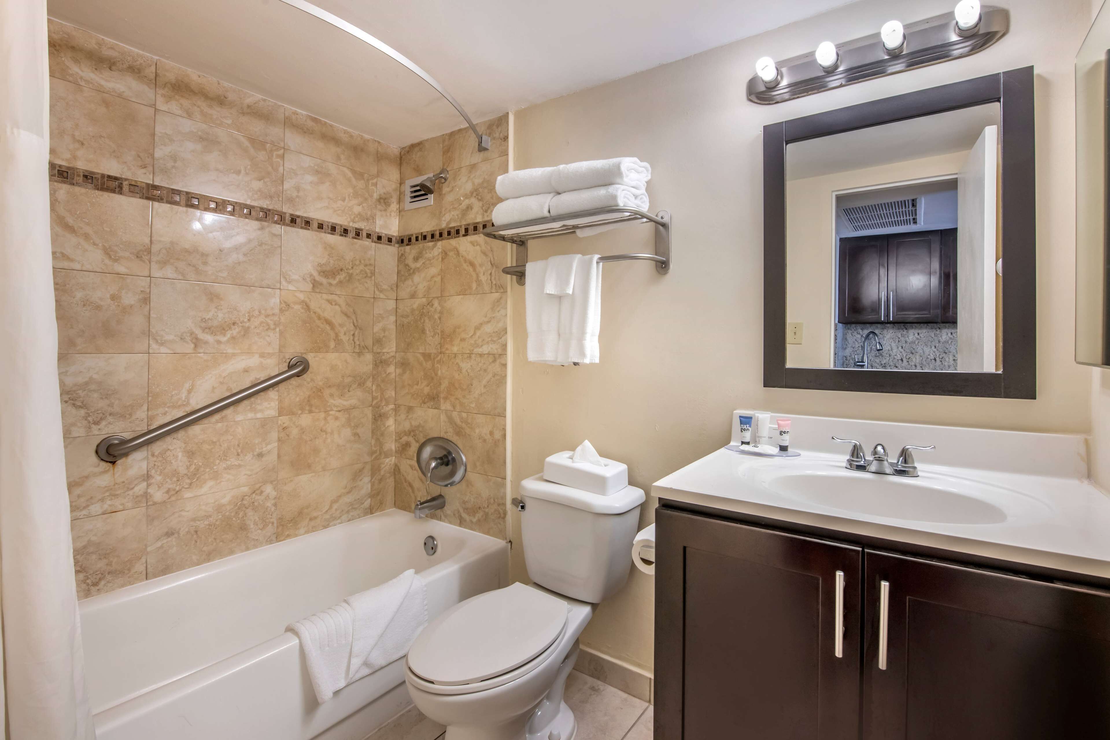 A bathroom with a bathtub, toilet, and sink.