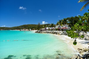 On the beach, white sand, sun loungers, beach umbrellas