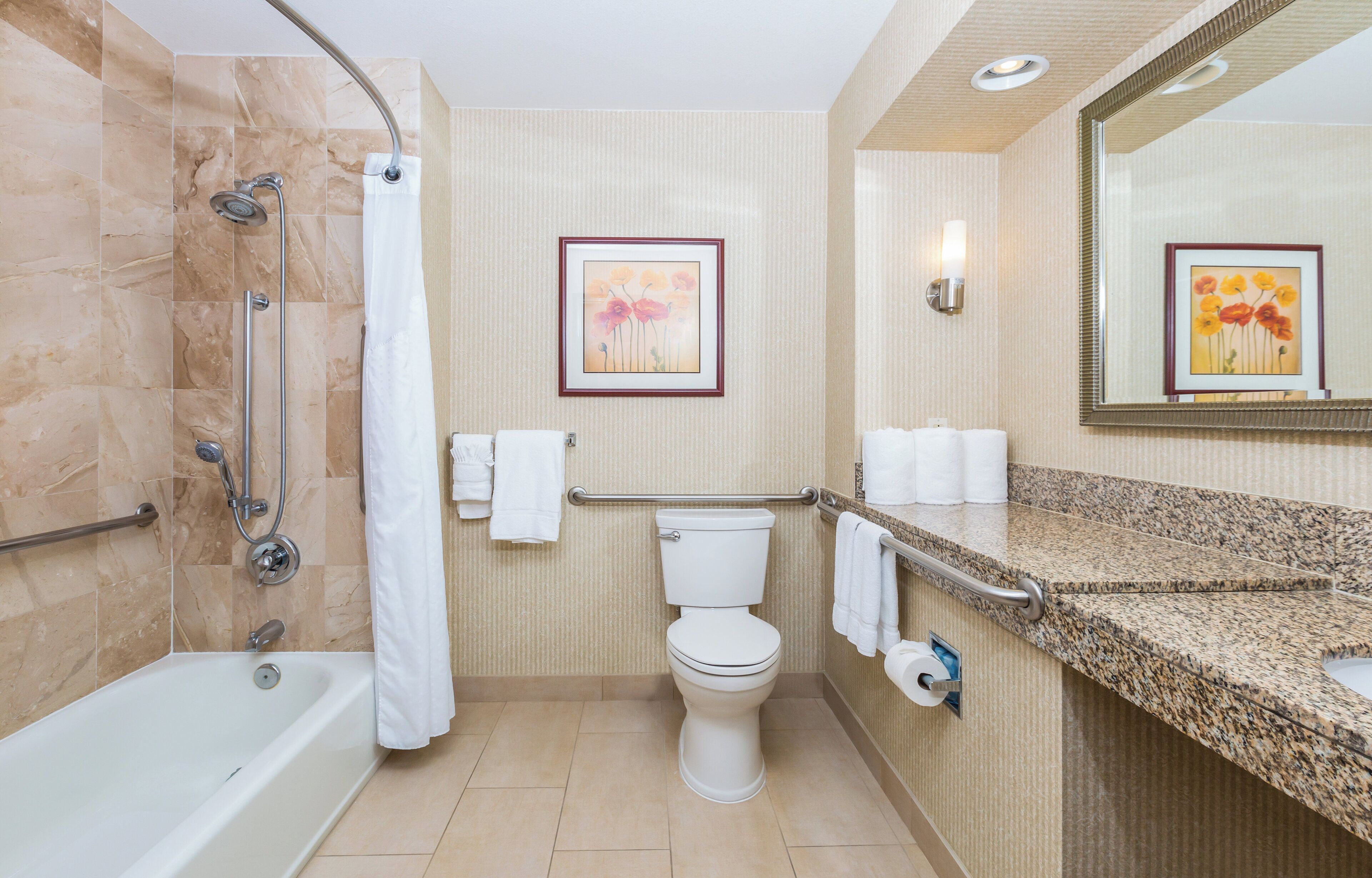 A bathroom with a shower, toilet, and sink.