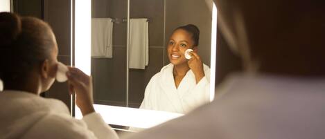 A bathroom with a mirror, a towel rack, and a sink.