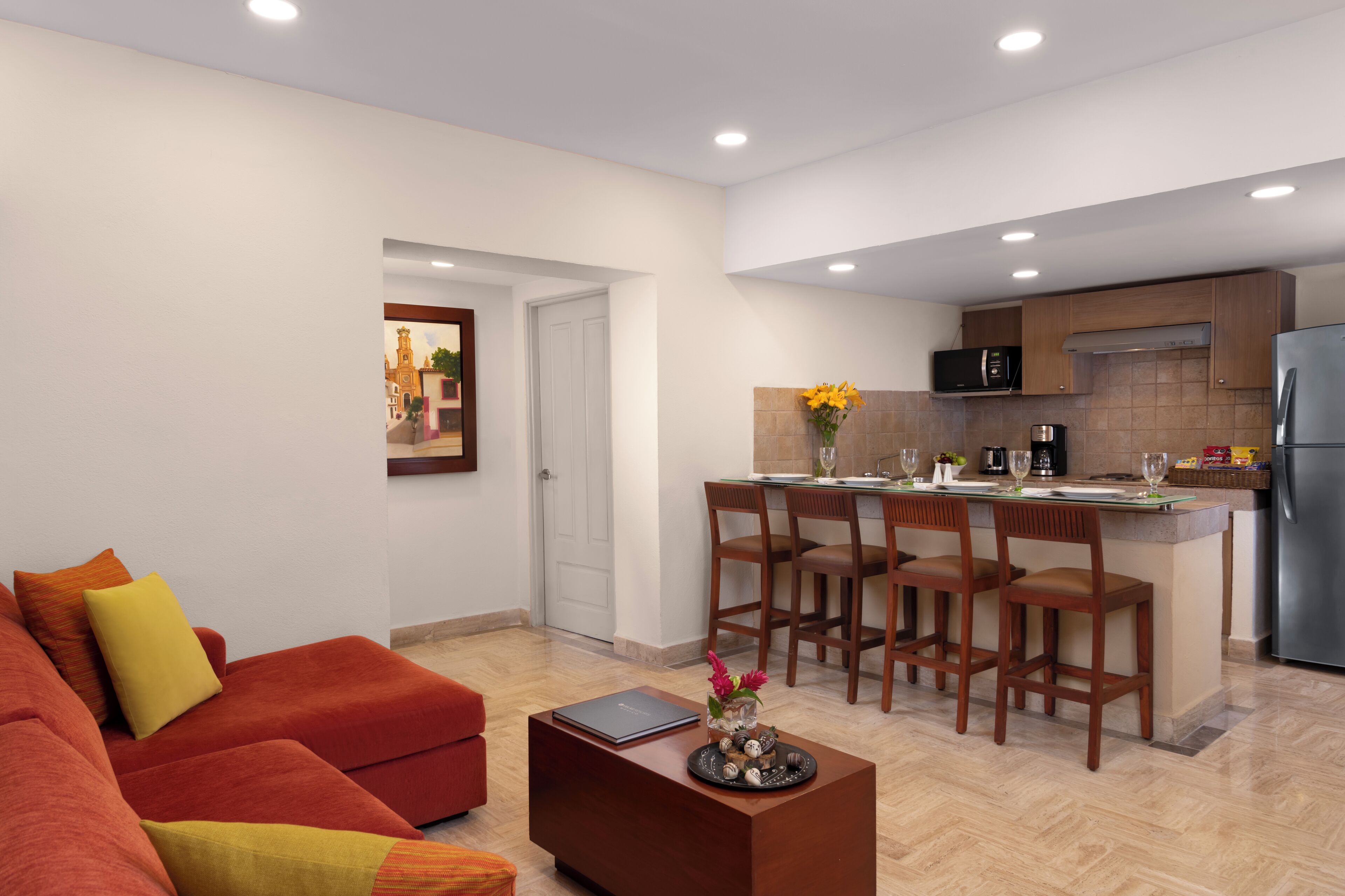 A modern apartment with a living room, kitchen, and dining area.