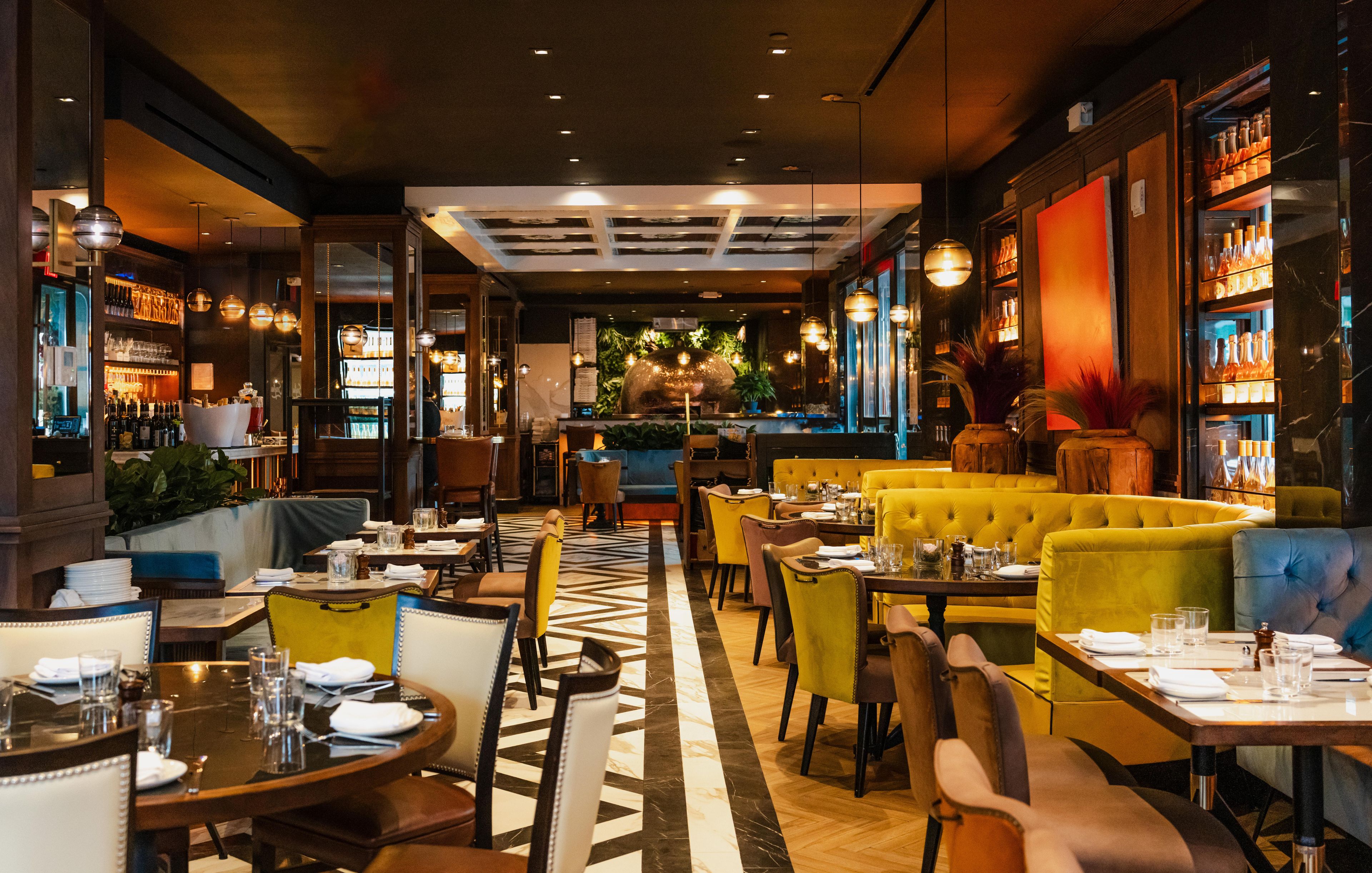 A restaurant interior with tables, chairs, and a bar area.