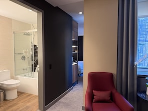 A modern bathroom with a glass shower enclosure, a toilet, and a bathtub. - NH Collection New York Madison Avenue (New York)