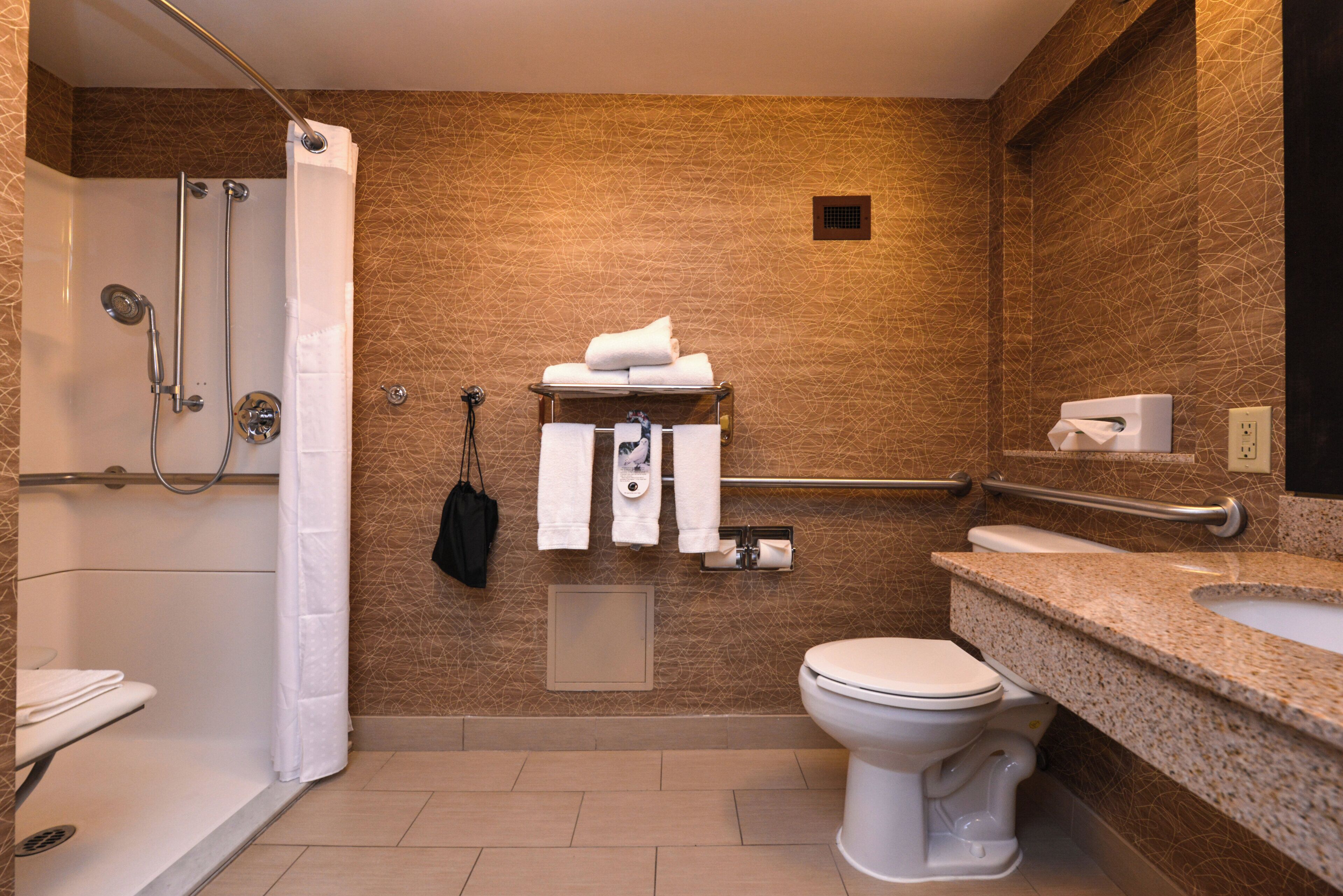 Un baño moderno con ducha, inodoro y lavamanos.