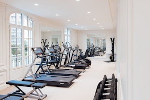 A gym with treadmills, ellipticals, and dumbbells. - Hôtel Barrière Le Normandy Deauville (Deauville)
